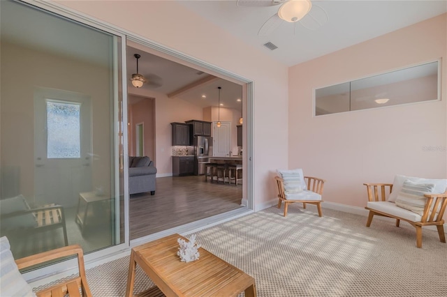 sitting room with carpet flooring and ceiling fan