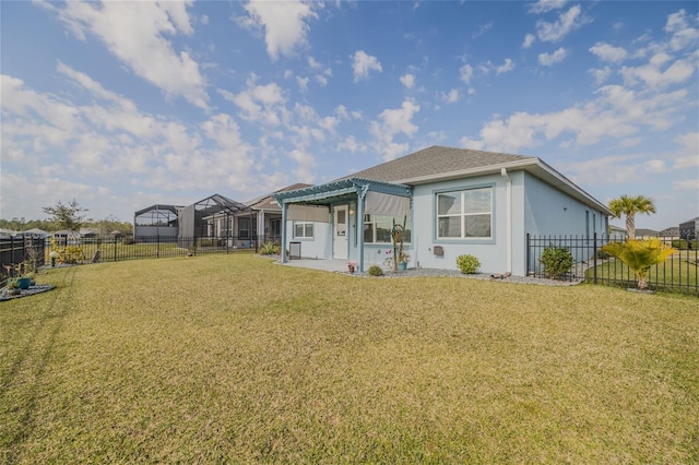 rear view of house with a patio, a yard, and a pergola