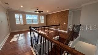 hall featuring dark hardwood / wood-style flooring and crown molding