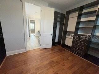 unfurnished bedroom with dark wood-type flooring