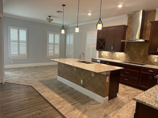 6301 Swanson St, Windermere, FL 34786 - kitchen with wall chimney range hood, a sink, baseboards, light stone countertops, and crown molding