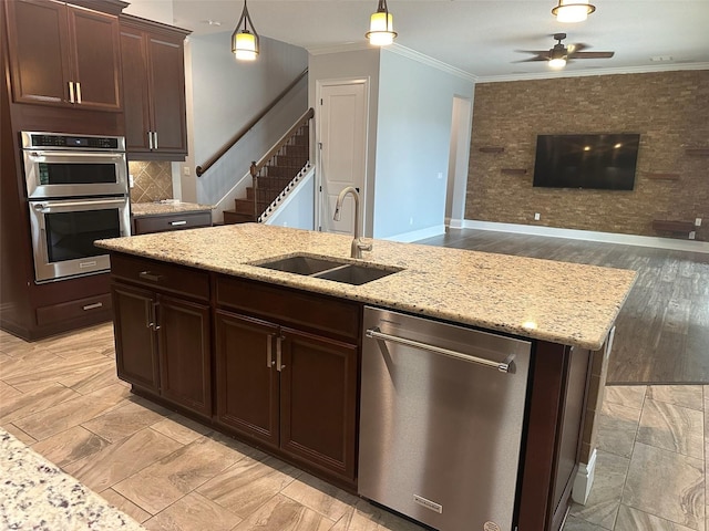 6301 Swanson St, Windermere, FL 34786 - kitchen with appliances with stainless steel finishes, a sink, ornamental molding, decorative light fixtures, and ceiling fan