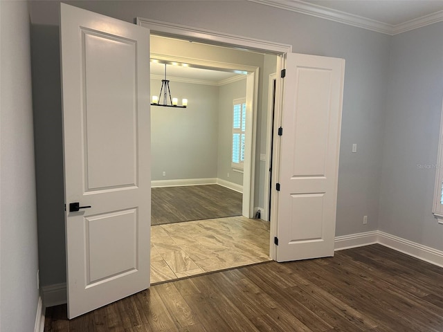 6301 Swanson St, Windermere, FL 34786 - empty room with dark wood-style flooring, a chandelier, ornamental molding, and baseboards