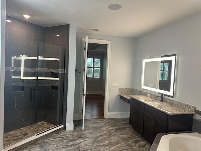 6301 Swanson St, Windermere, FL 34786 - full bath featuring vanity, a shower stall, baseboards, a bathtub, and marble look tile flooring