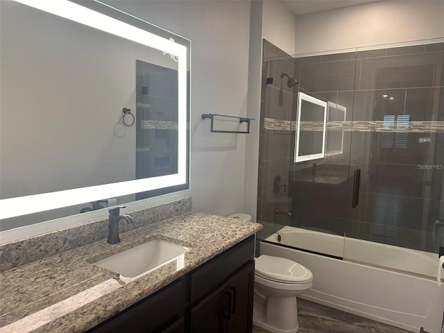 6301 Swanson St, Windermere, FL 34786 - full bathroom with vanity, toilet, bath / shower combo with glass door, and wood finished floors