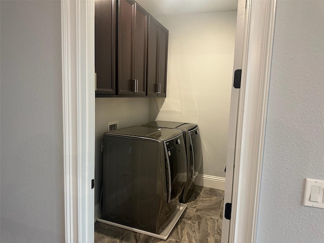 6301 Swanson St, Windermere, FL 34786 - laundry room with cabinet space, dark marble finish floors, washing machine and clothes dryer, and baseboards