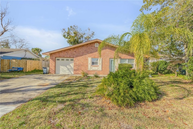 single story home featuring a garage and a front yard