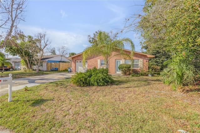 single story home featuring a garage and a front yard