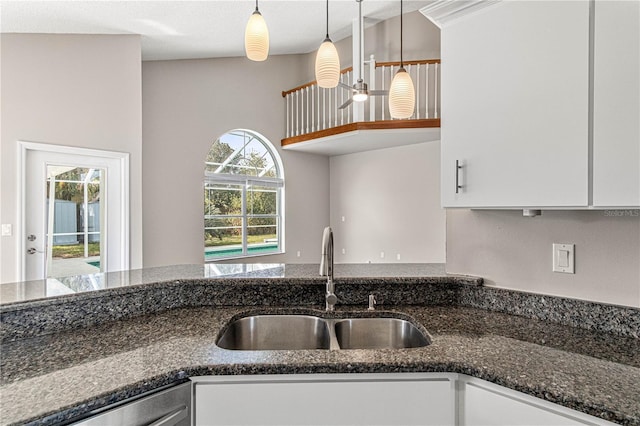 kitchen with pendant lighting, white cabinets, and a sink