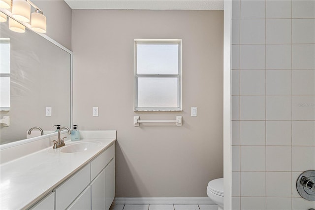 full bathroom with baseboards, vanity, toilet, and walk in shower