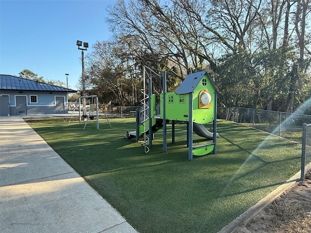 communal playground with fence and a yard