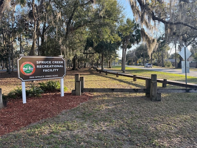 view of home's community featuring fence and a yard