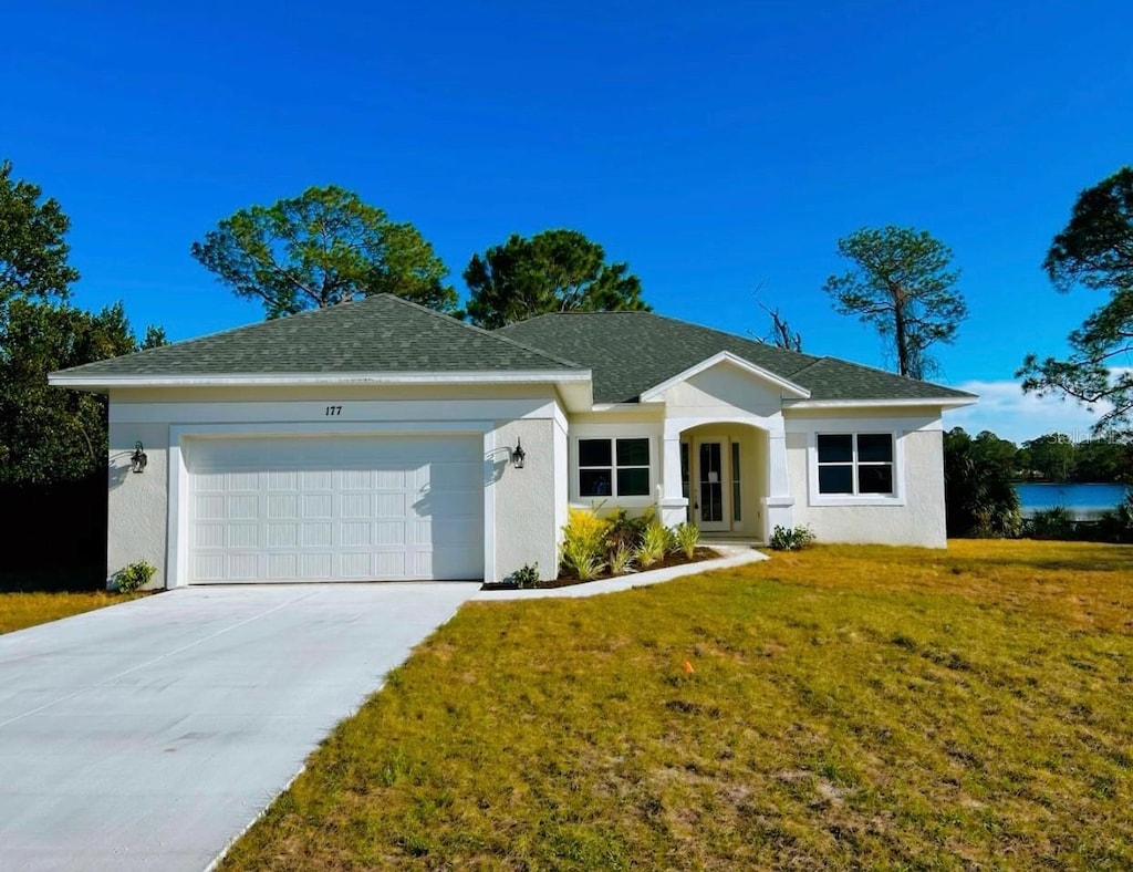 single story home featuring a garage and a front yard