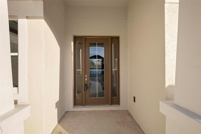 view of exterior entry with stucco siding