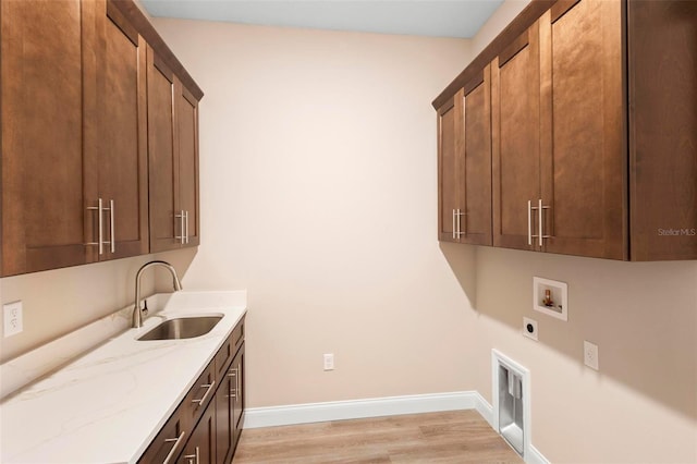 laundry area with cabinet space, baseboards, hookup for a washing machine, hookup for an electric dryer, and a sink