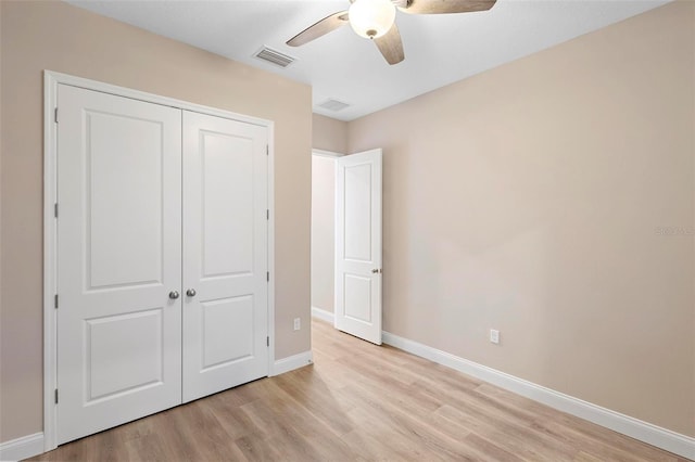 unfurnished bedroom featuring light wood finished floors, a closet, visible vents, and baseboards