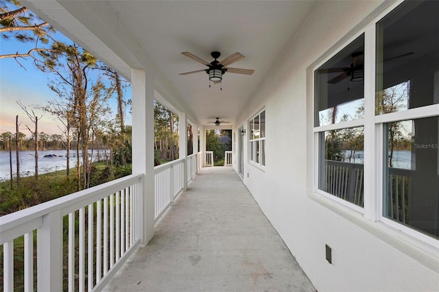 patio terrace at dusk featuring ceiling fan