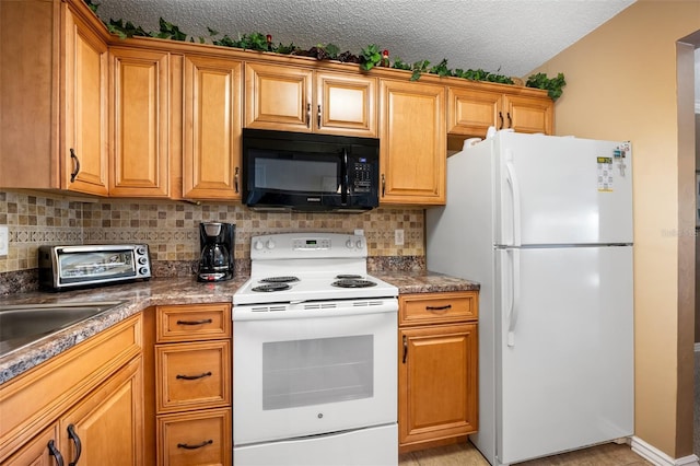 kitchen featuring tasteful backsplash, white appliances, and a textured ceiling