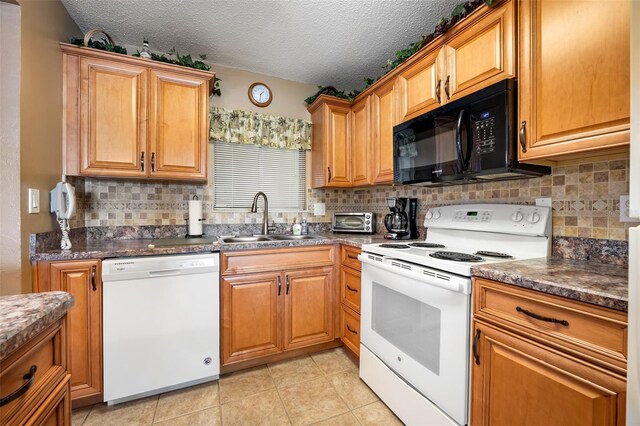 kitchen featuring sink, tasteful backsplash, a textured ceiling, light tile patterned floors, and white appliances