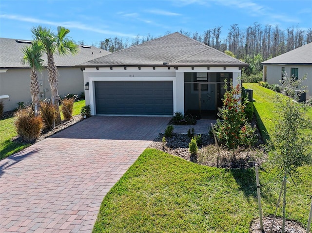 view of front of property featuring a garage and a front yard