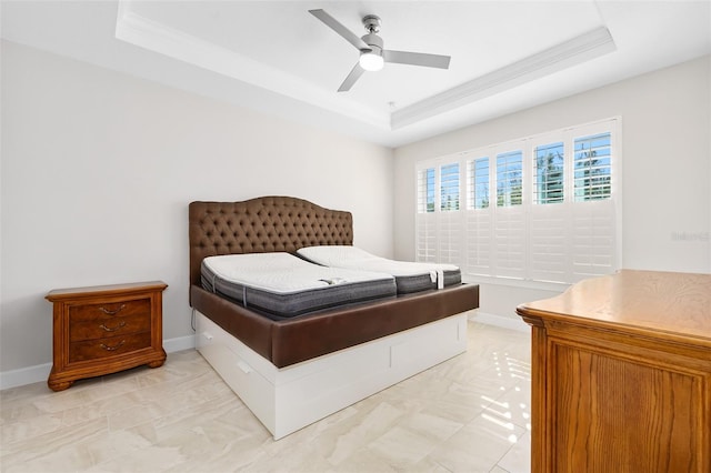 bedroom featuring crown molding, ceiling fan, and a tray ceiling