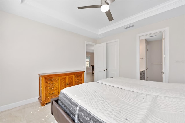 bedroom with a raised ceiling and ceiling fan