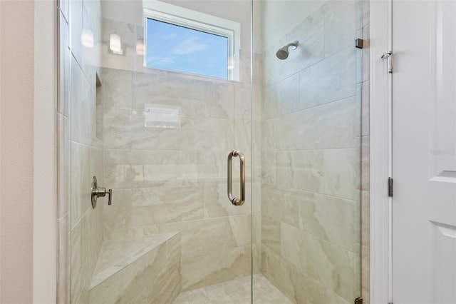 bathroom with a shower with shower door