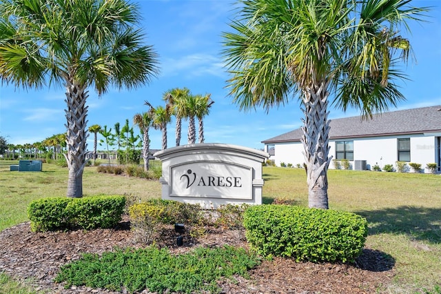 community sign featuring a lawn