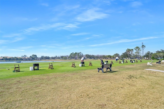 view of community with a water view and a lawn