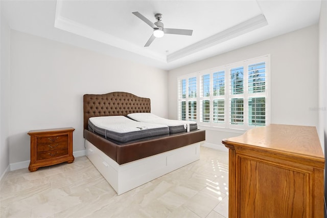 bedroom with crown molding, a raised ceiling, and ceiling fan