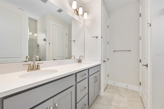 bathroom with vanity and a shower with shower door