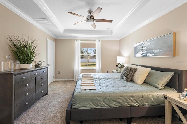 carpeted bedroom with crown molding, ceiling fan, and a tray ceiling