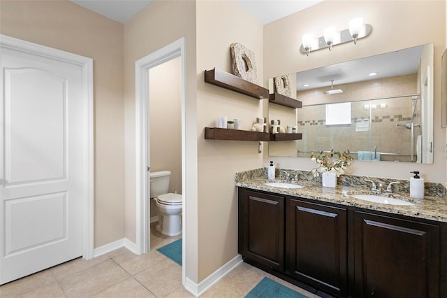 bathroom featuring tile patterned flooring, walk in shower, vanity, and toilet