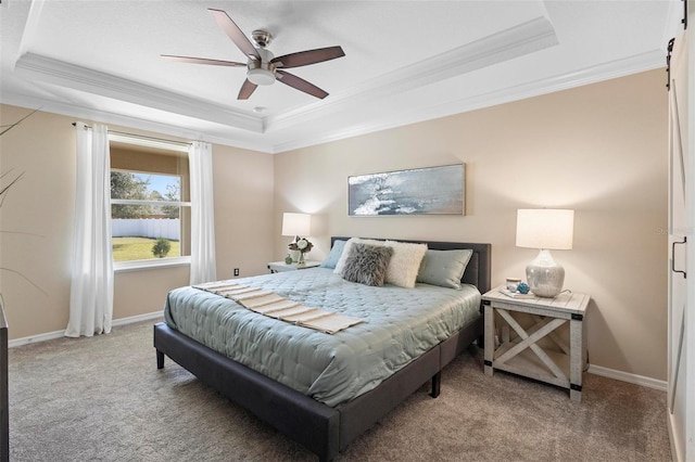 carpeted bedroom with ceiling fan, ornamental molding, and a tray ceiling