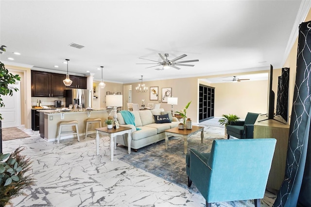 living room with crown molding and ceiling fan with notable chandelier