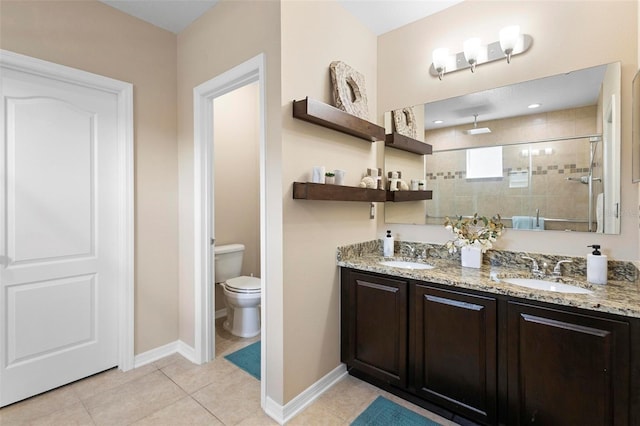full bath featuring toilet, a sink, double vanity, and a stall shower