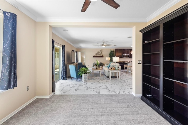 interior space featuring ornamental molding, baseboards, and ceiling fan