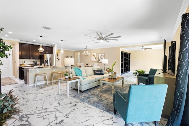 living area featuring visible vents, recessed lighting, ceiling fan with notable chandelier, marble finish floor, and ornamental molding