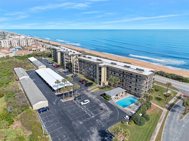 drone / aerial view featuring a water view and a view of the beach