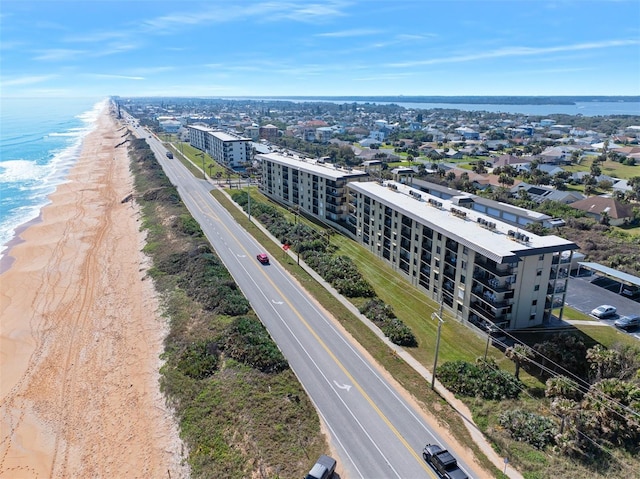 drone / aerial view featuring a water view and a view of the beach