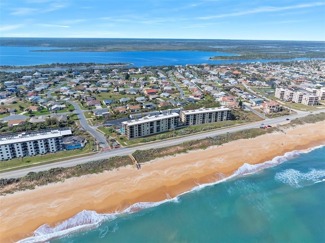 drone / aerial view featuring a water view and a view of the beach