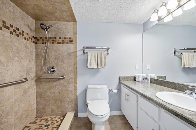 3180 Ocean Shore Blvd Unit 309, Ormond Beach, FL 32176 - bathroom featuring tiled shower, toilet, vanity, tile patterned floors, and a textured ceiling