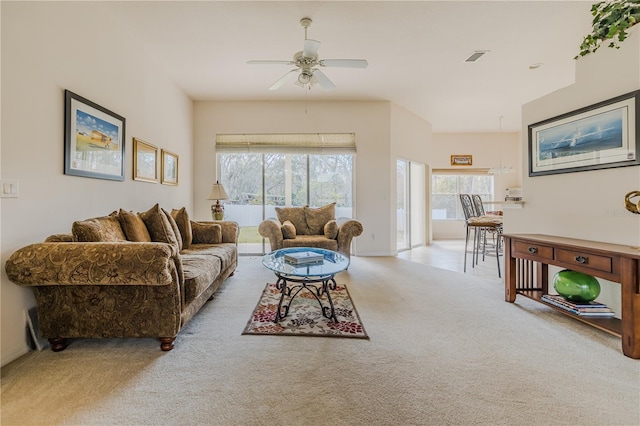 carpeted living room featuring ceiling fan