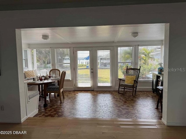 dining area with plenty of natural light, french doors, and wood-type flooring