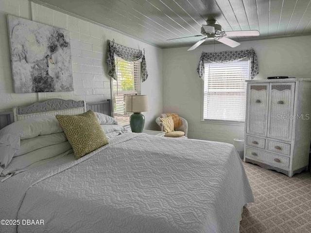 bedroom with ceiling fan, light carpet, and wooden ceiling