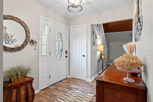 entryway featuring hardwood / wood-style flooring and a chandelier