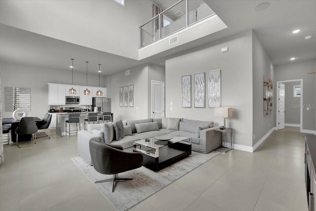 living room featuring a high ceiling