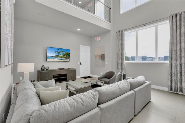 tiled living room featuring a towering ceiling