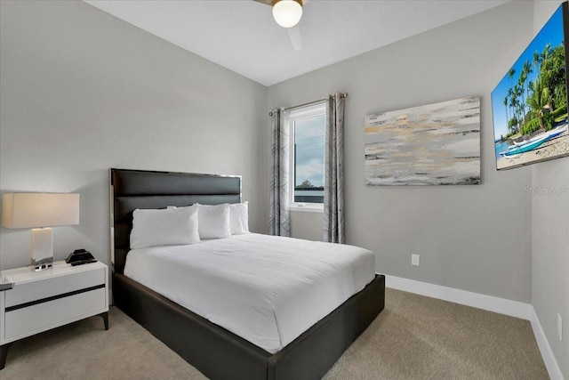 bedroom featuring light carpet and ceiling fan