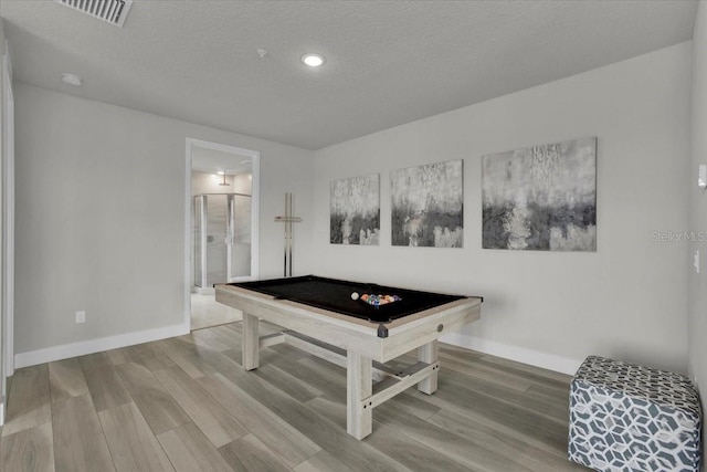 recreation room featuring hardwood / wood-style floors, a textured ceiling, and pool table